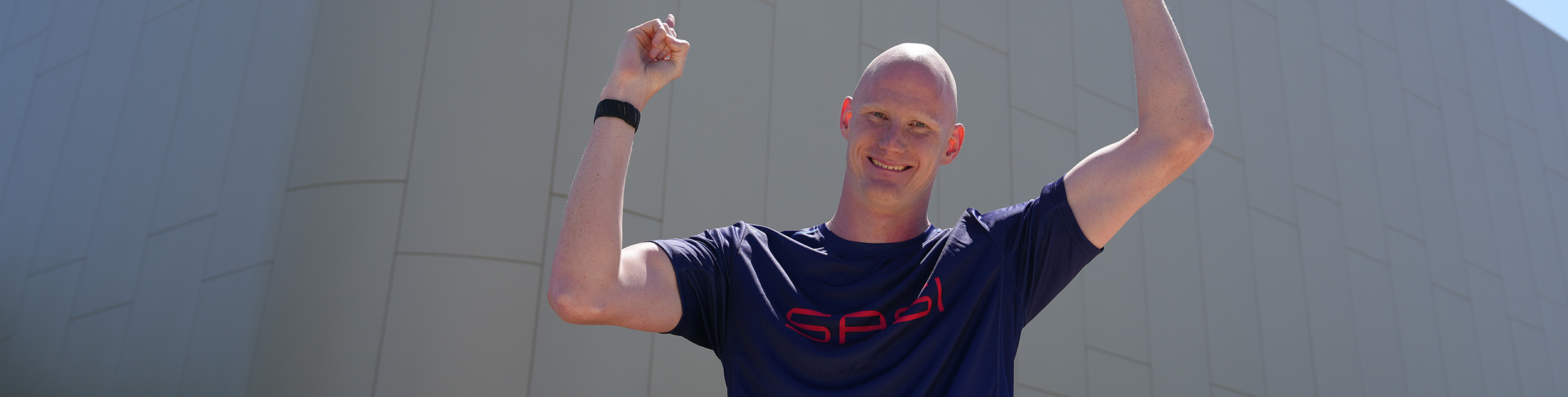 Rowan Crothers pointing at the SASI building in the background