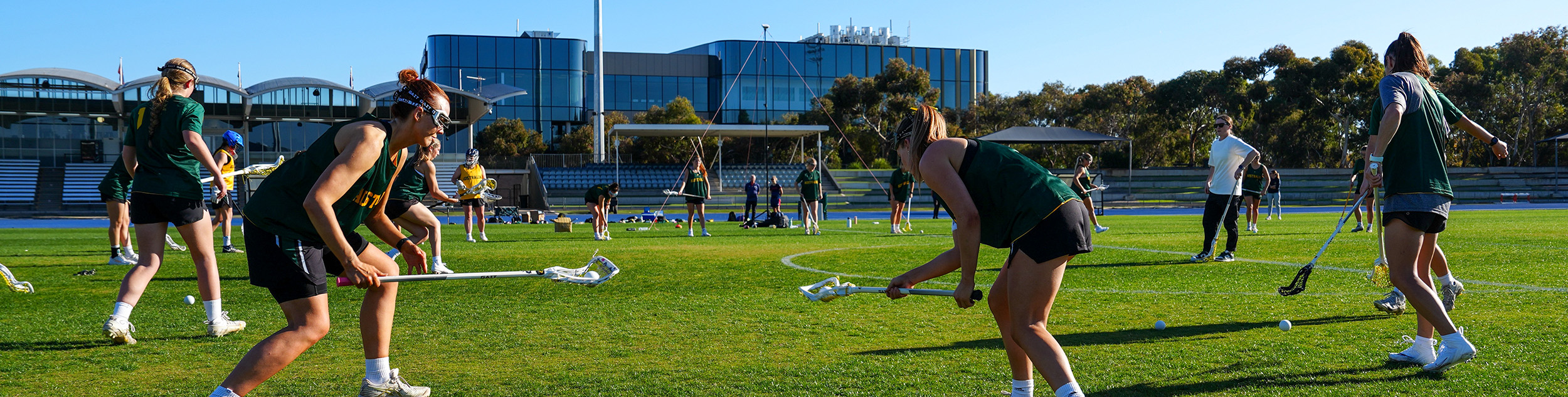 Female lacrosse players on a field