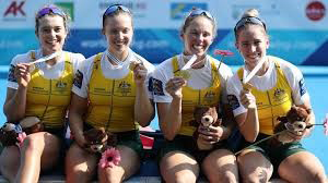 Rowers sitting with medals in their hands