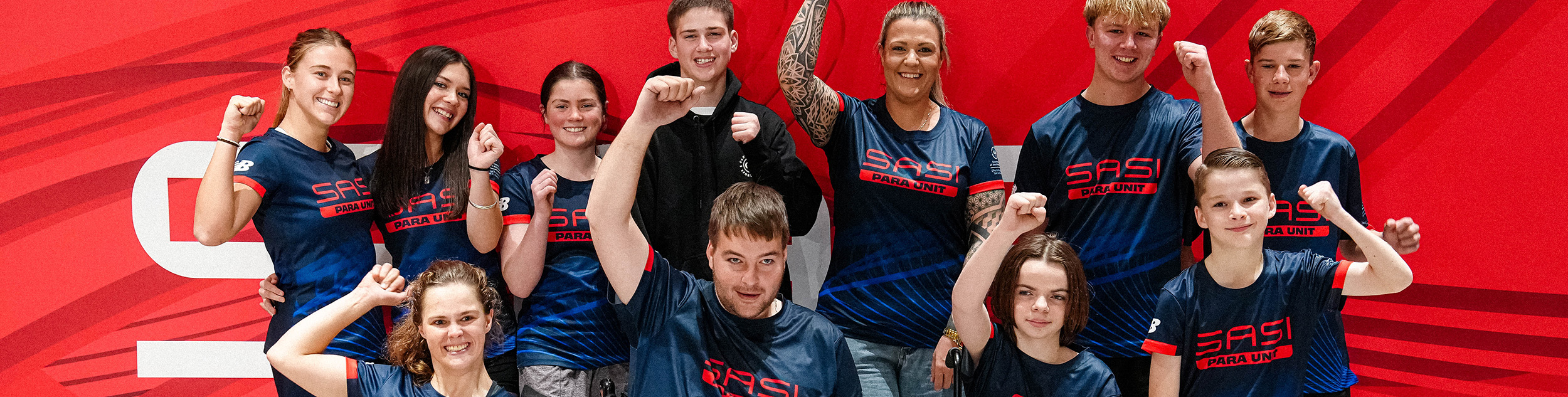 Para Unit graduates with their fists in the air
