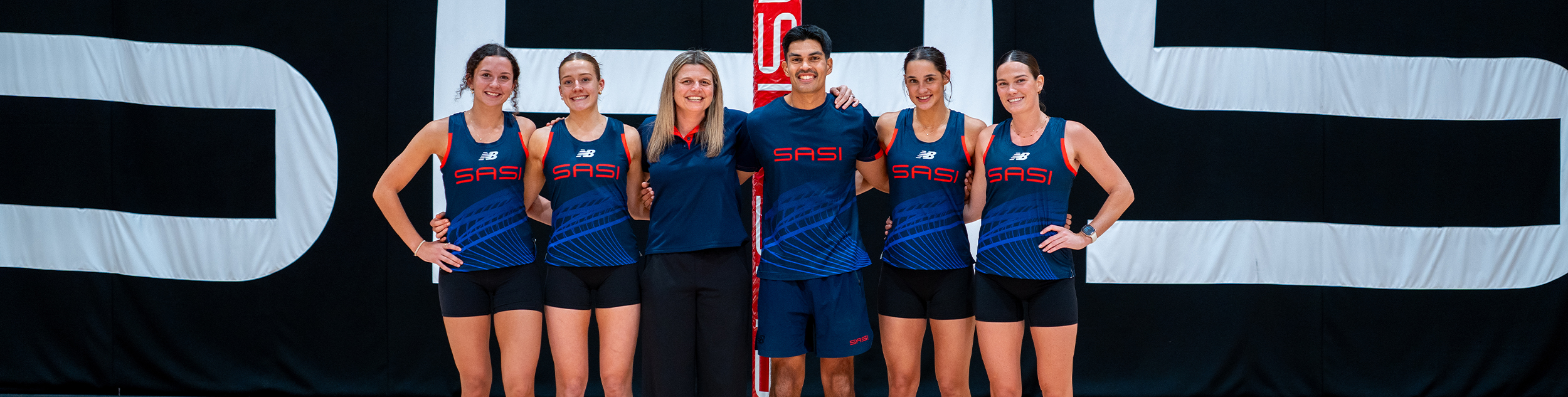 SASI netballers and support staff on court