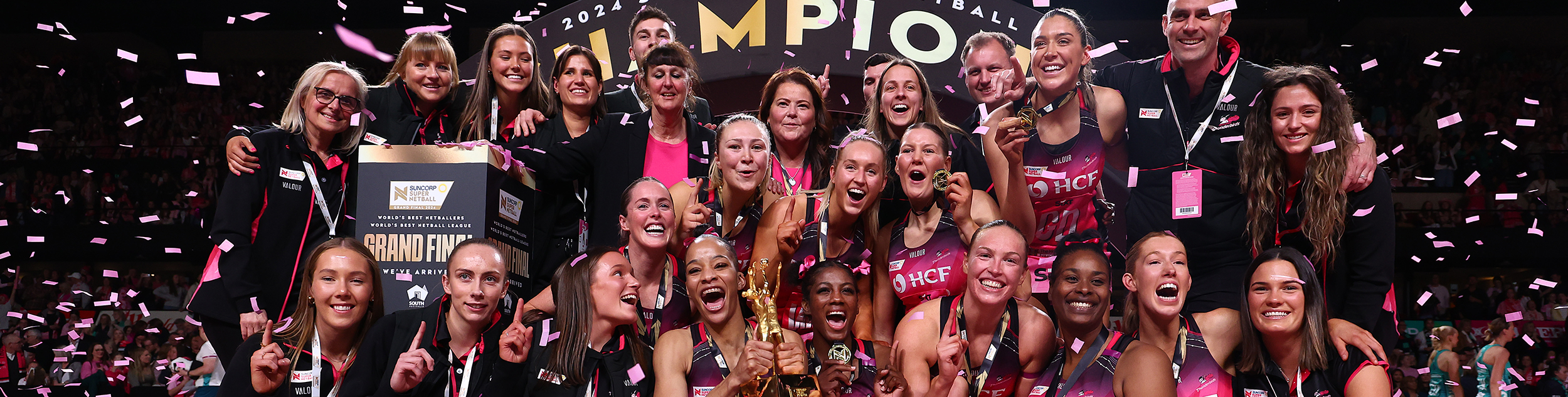 Adelaide Thunderbirds team celebrate win with confetti falling from the ceiling